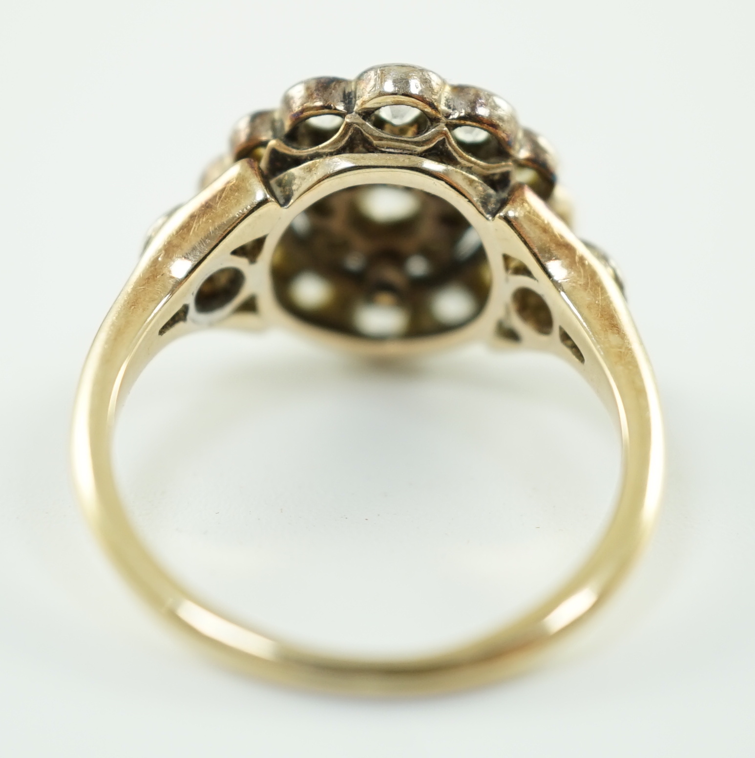 A mid 20th century gold and millegrain set diamond cluster target ring